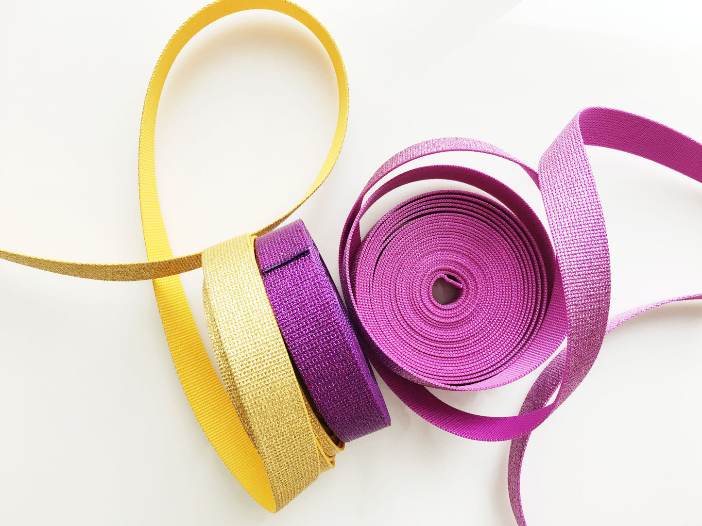 Gold glitter and purple webbing rolls