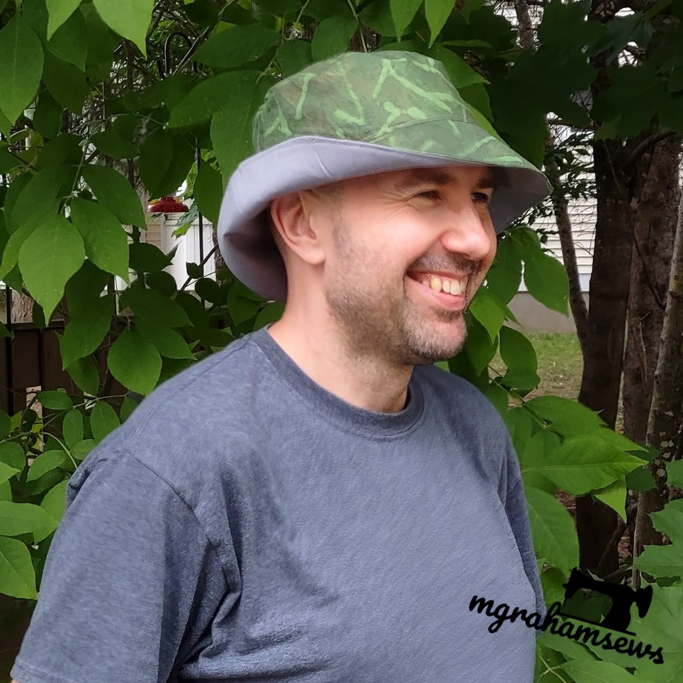 Graham wearing a camo hat and smiling