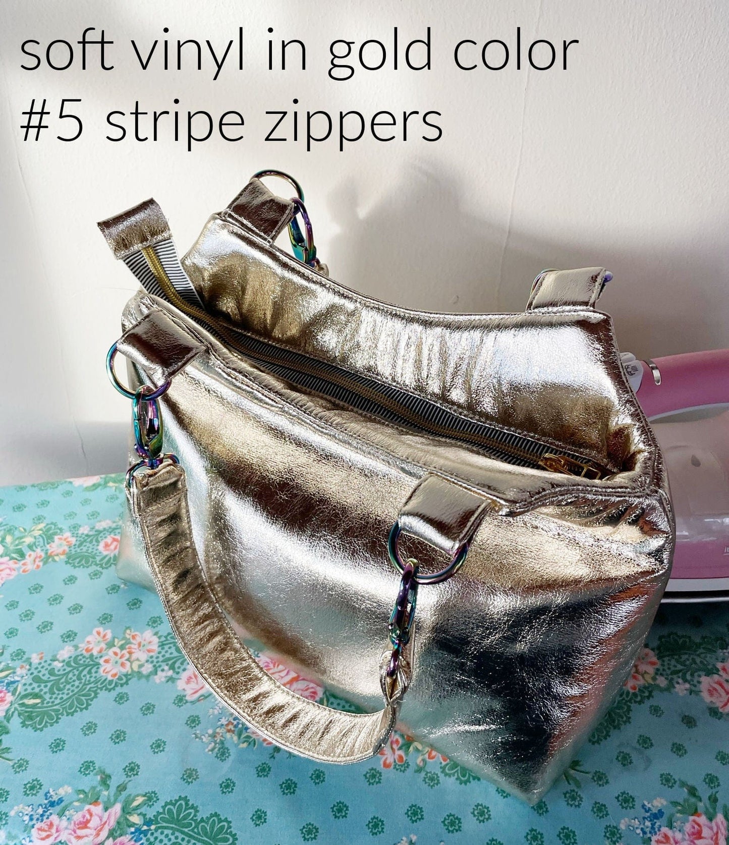 Gold vinyl bag with stripe zippers