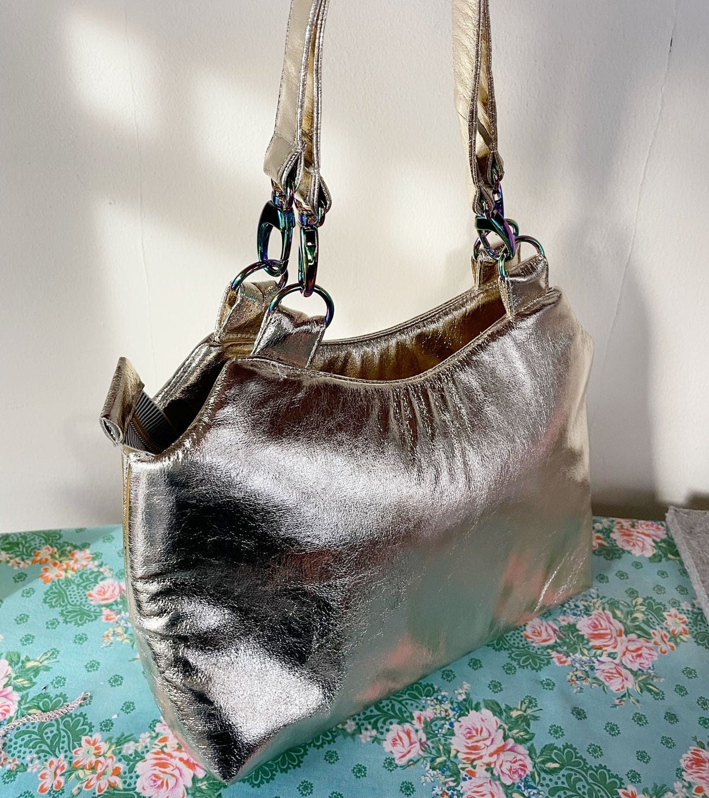 Metallic gold handbag on floral fabric