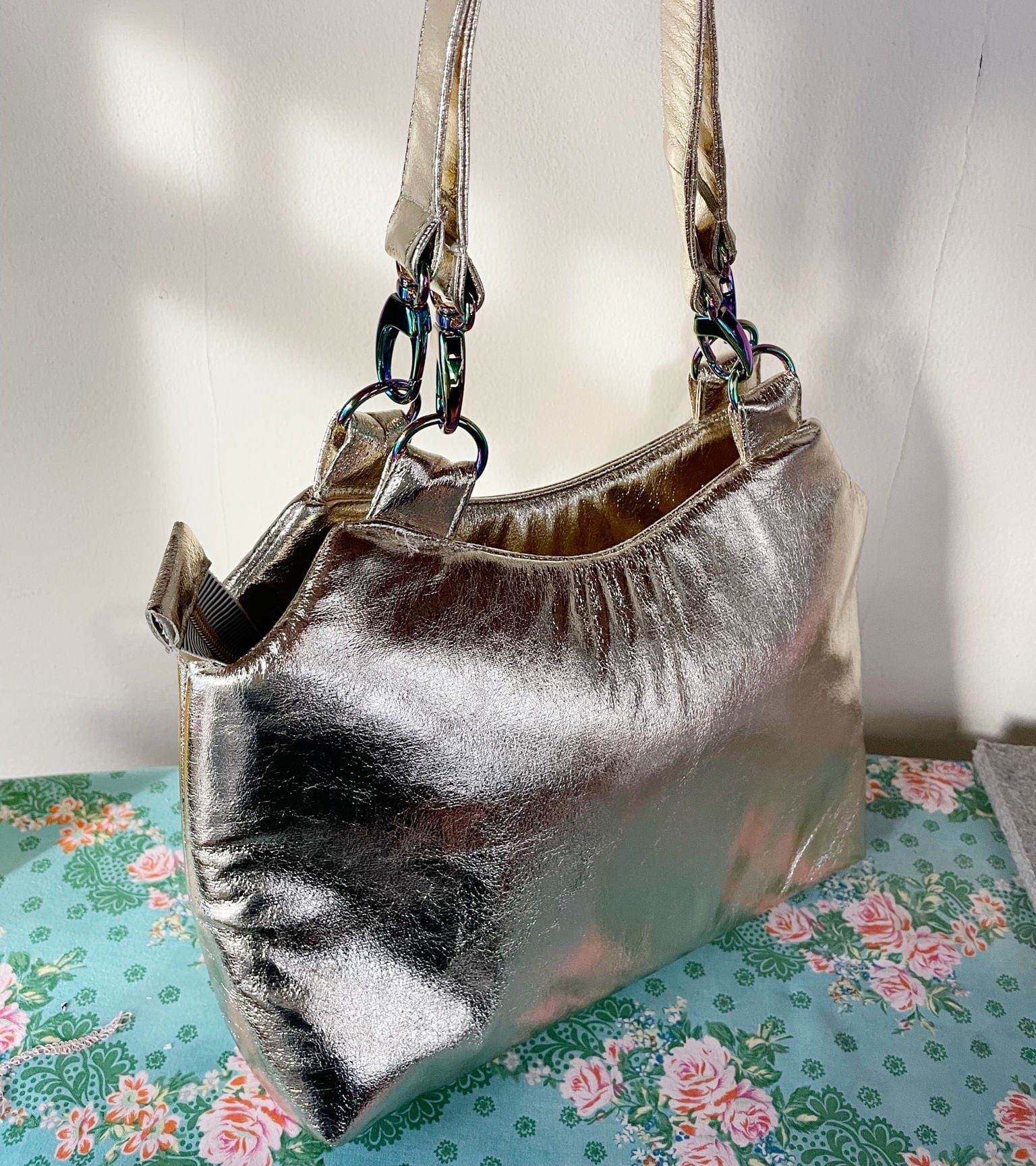 Metallic gold handbag on floral fabric