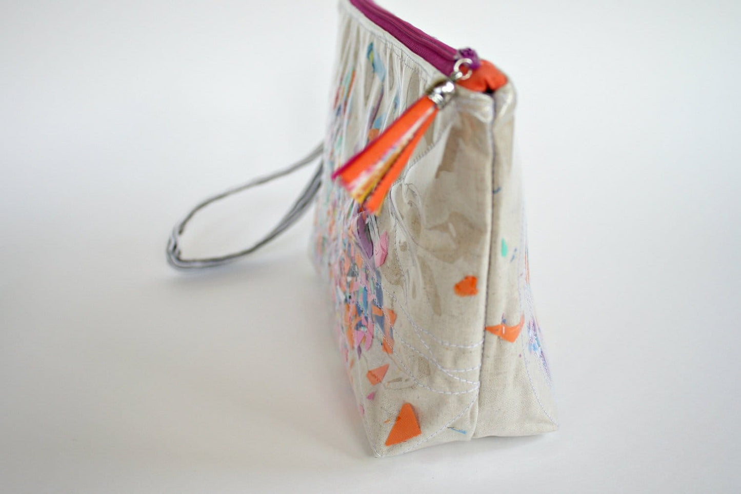 Cosmetic bag with colorful print and tassel detail