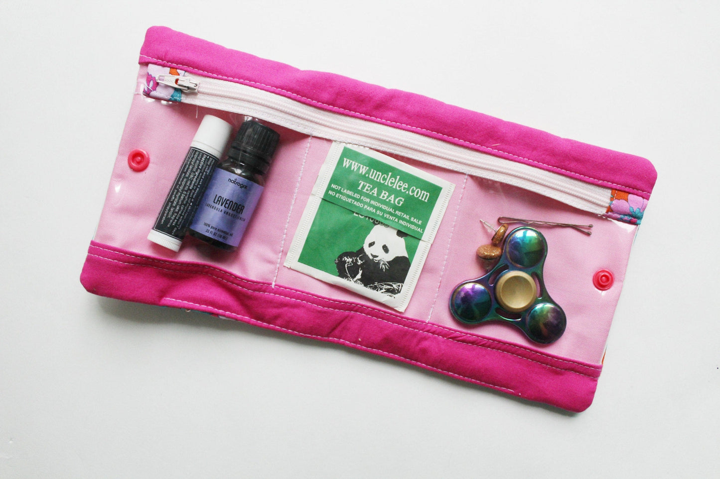 Pink zippered pouch with essentials