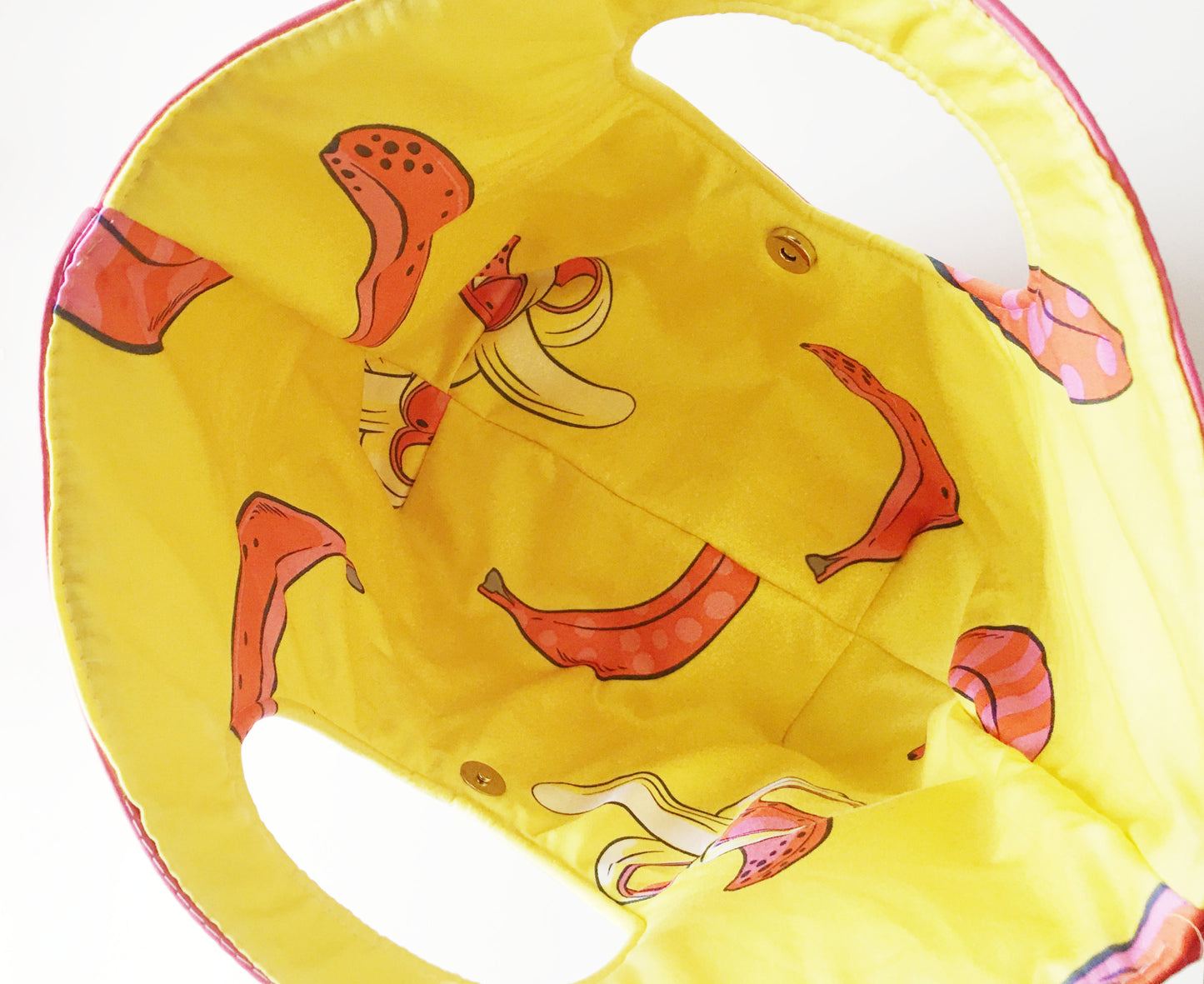 Inside of a yellow banana bag with fruit print