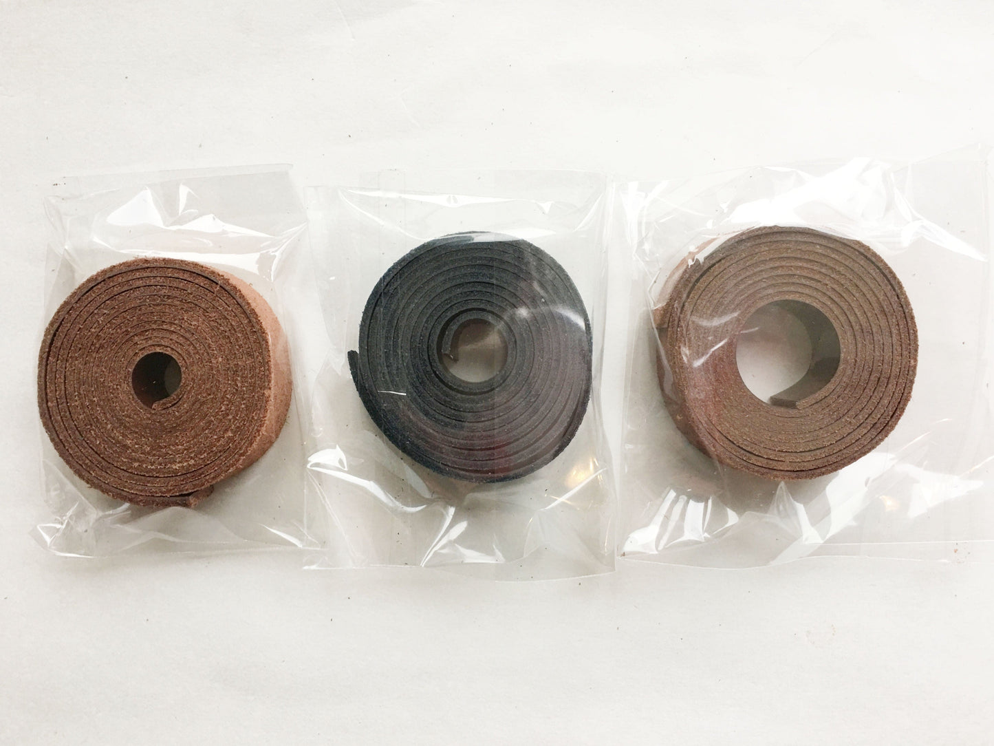 Leather straps for bags in brown, black, and tan