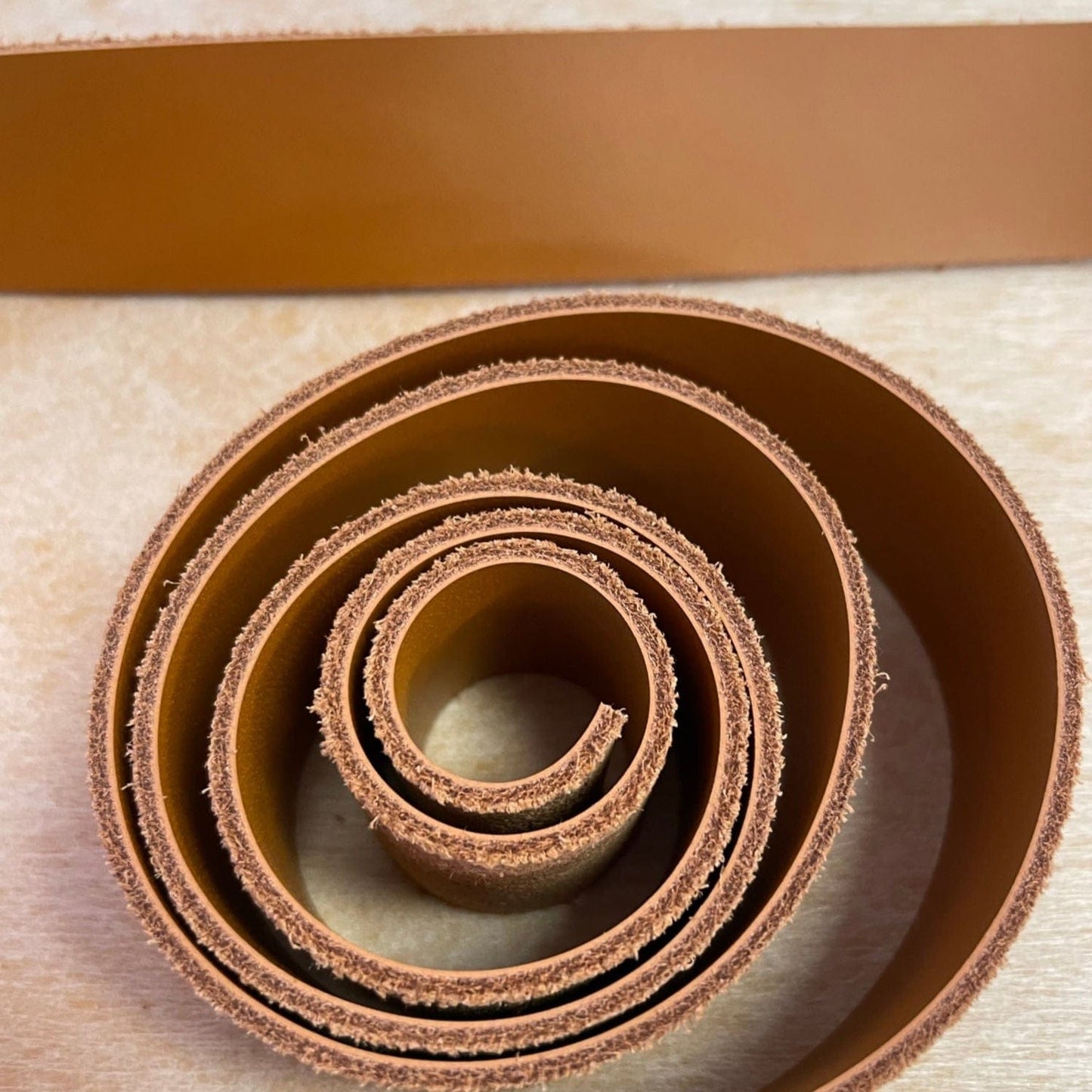 Light brown leather strap rolled up