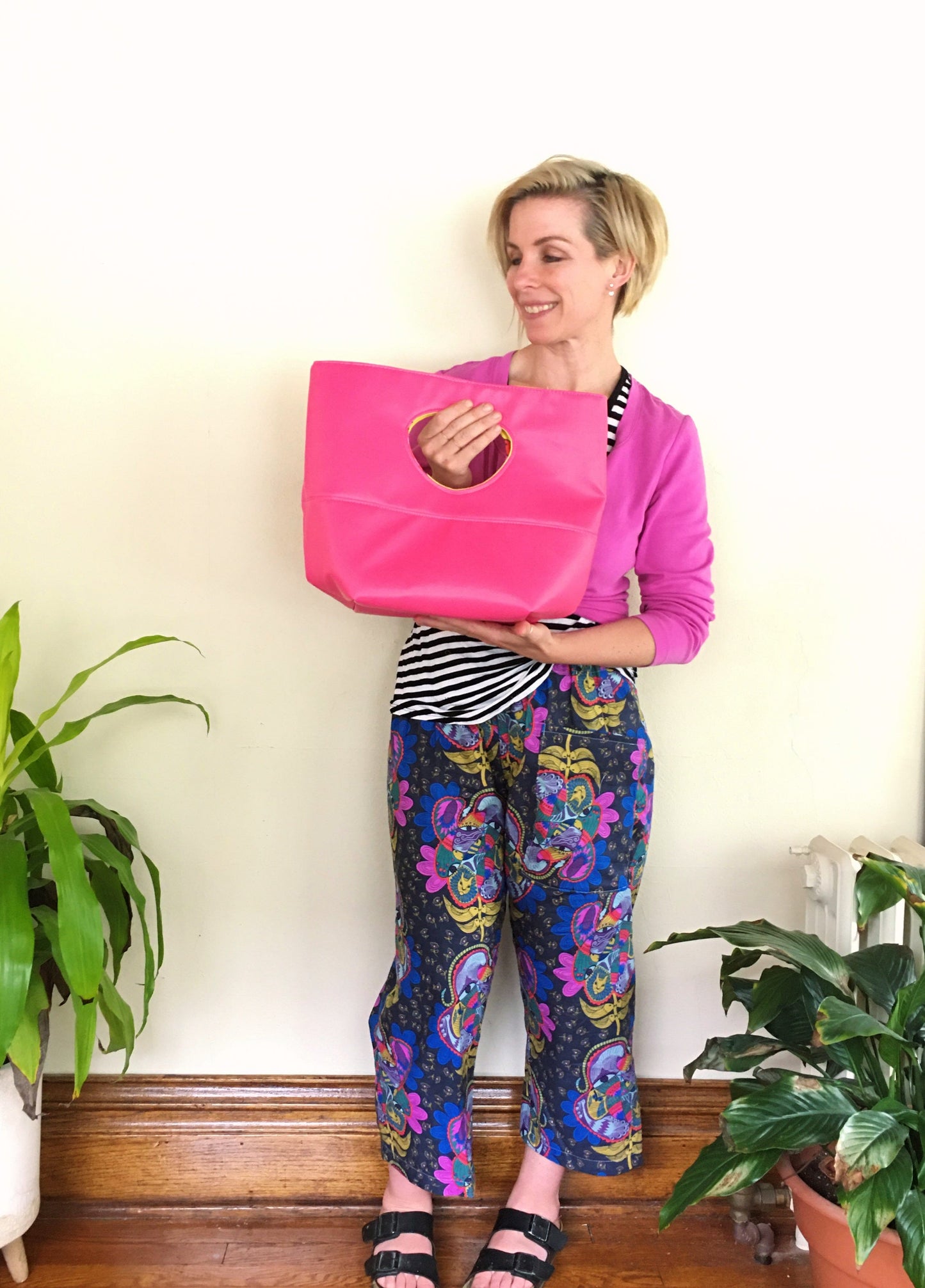 Natalie holding pink Naomi bag