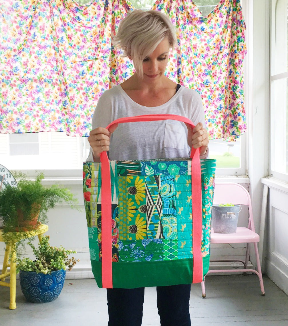 Woman holding the other side of a colorful tote bag