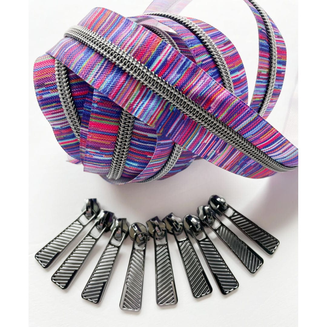 Purple zipper pack with colorful striped fabric and metal pulls.
