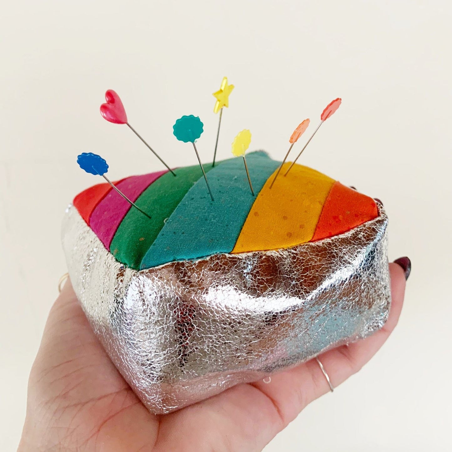 Sew Hungry Hippie pincushion with rainbow fabric and pins