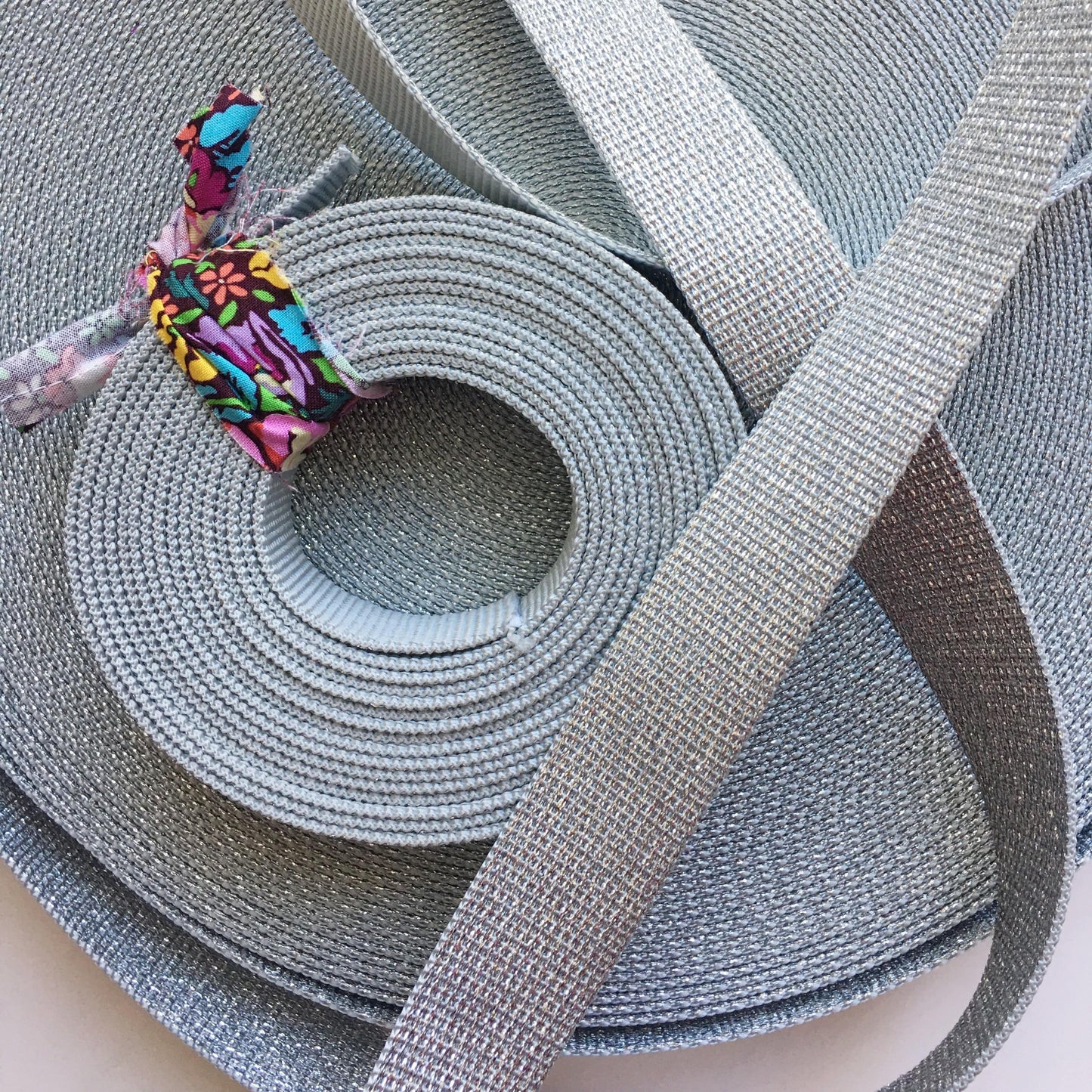 Silver webbing ribbon, rolled and flat