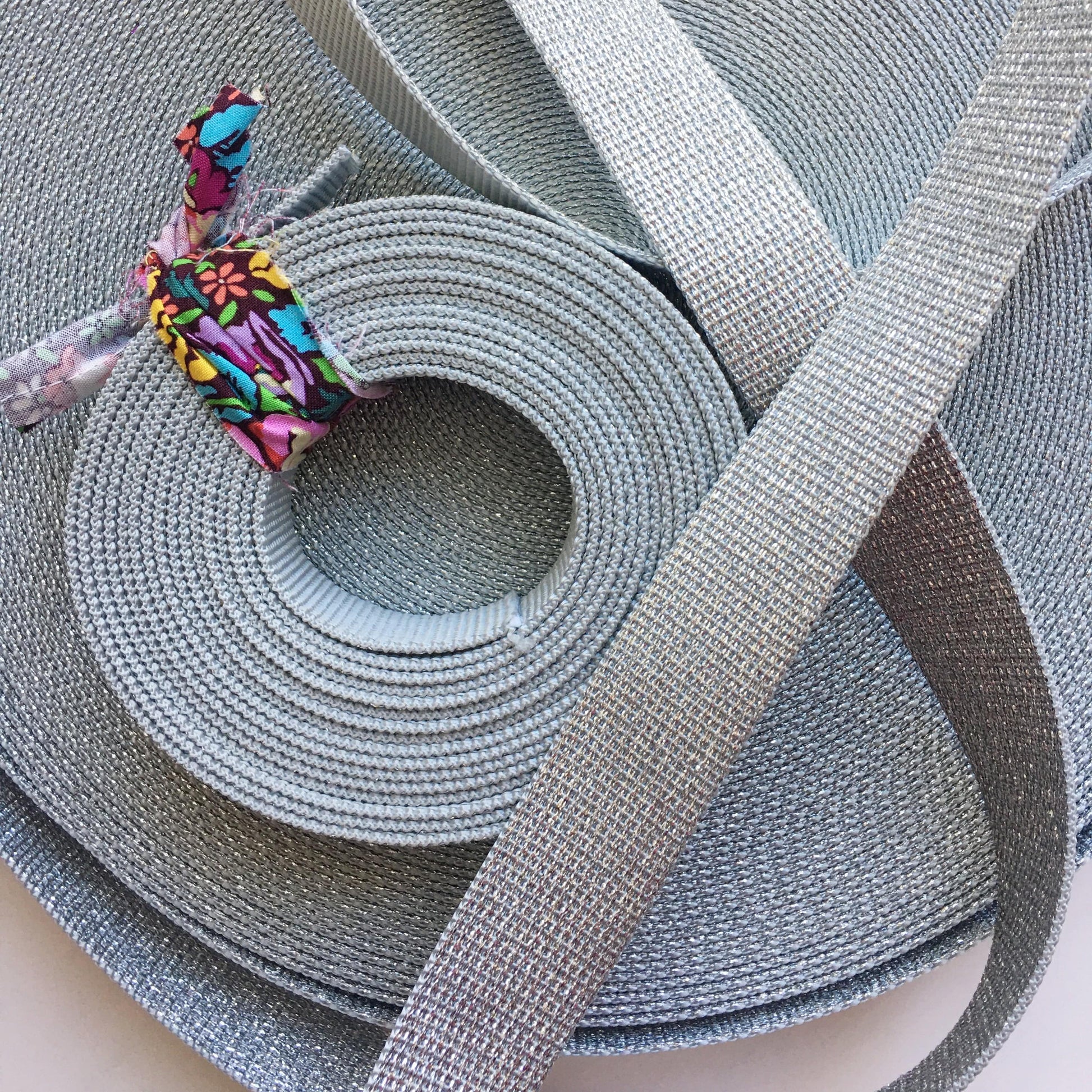 Silver webbing ribbon, rolled and flat