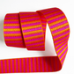 A 1.5-inch wide jacquard woven webbing strap showcasing a vibrant hot pink and orange horizontal stripe pattern, loosely coiled against a white background.