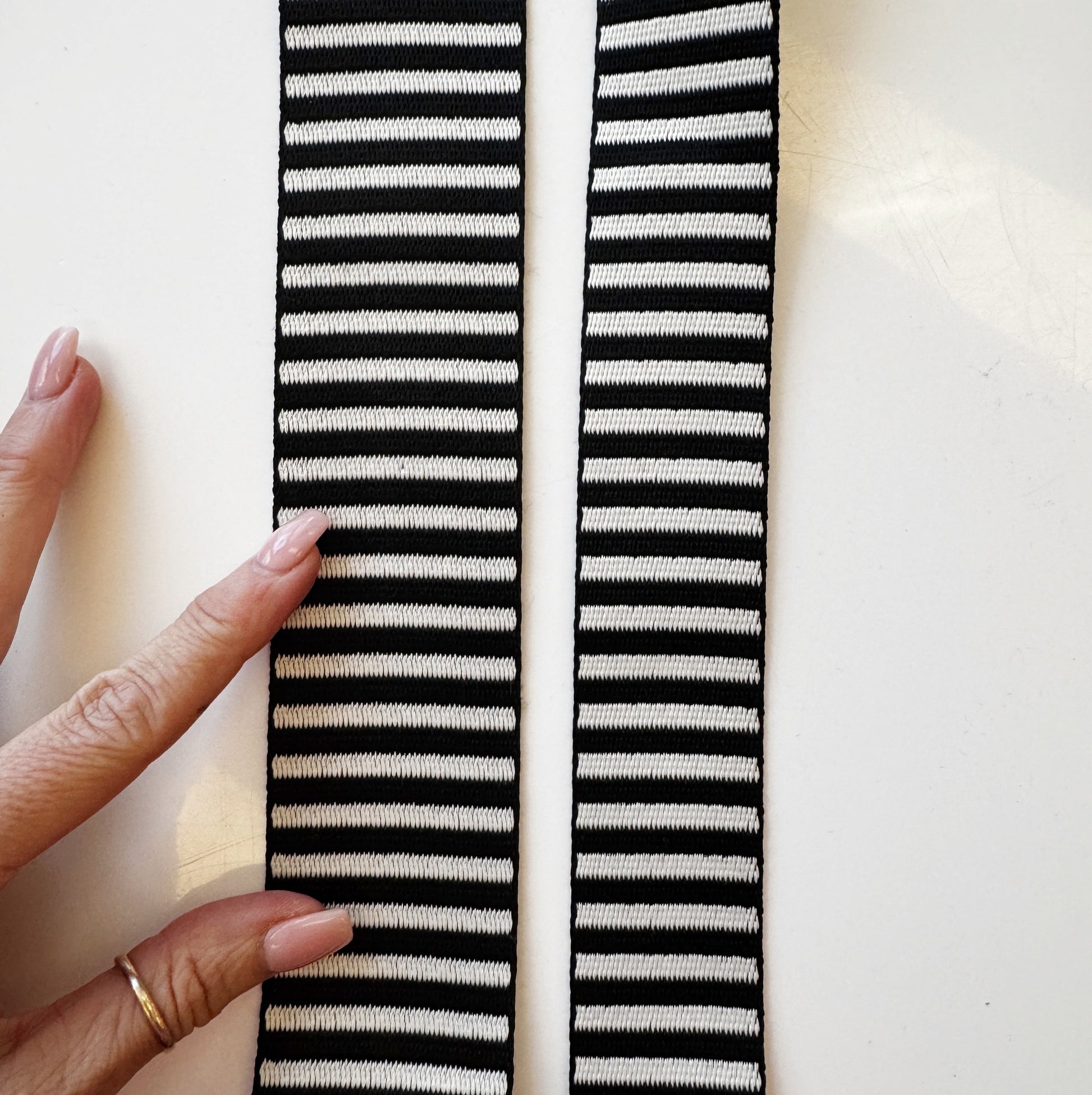 Black and white jacquard woven stripe webbing, 2-inch width, sold per yard. Strong decorative strap material for bag straps, purse handles, belts, and sewing projects.