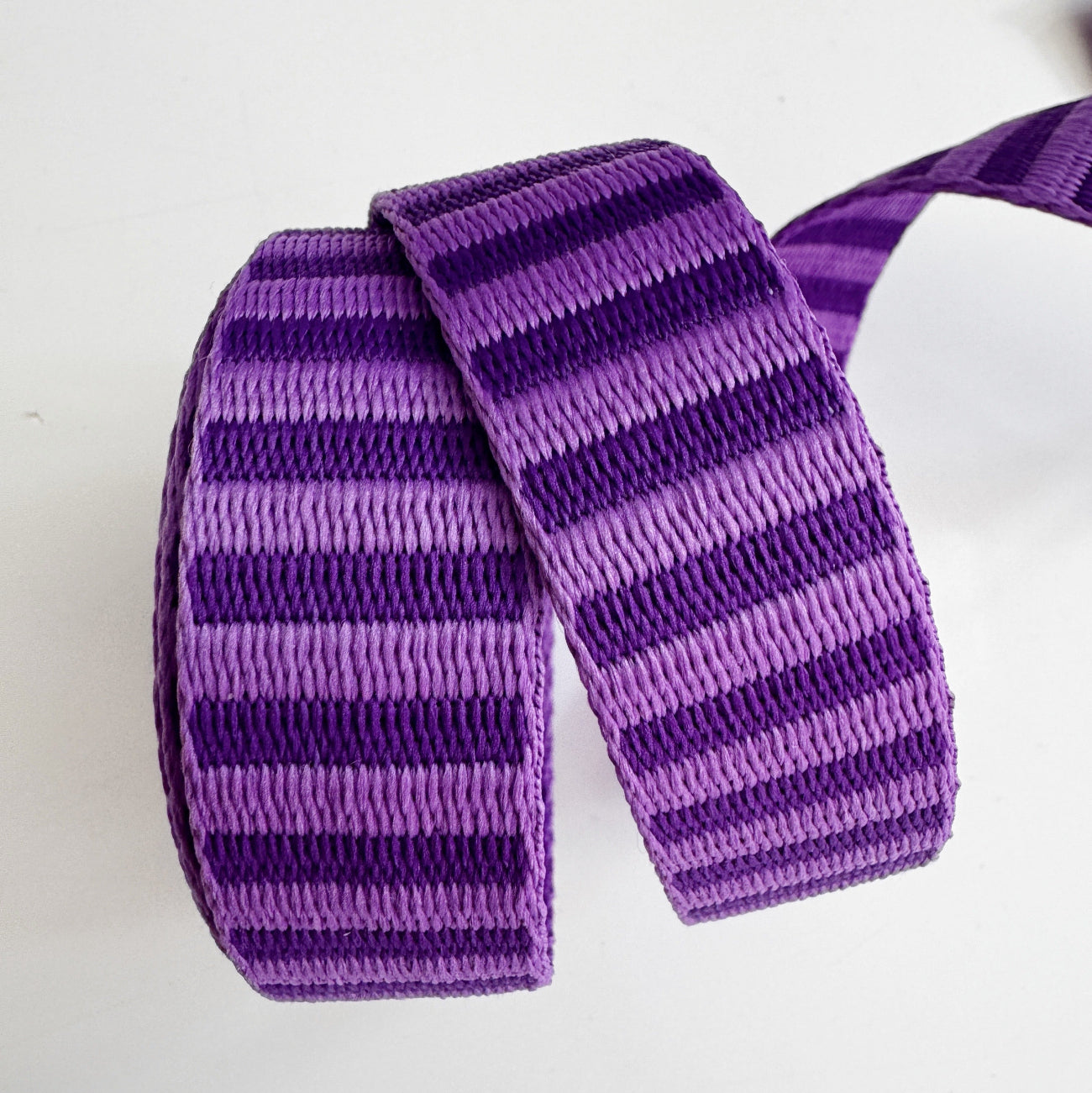 Purple striped strapping on a white background