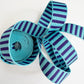 Coiled 1-inch wide woven striped webbing in teal blue and deep purple for bag straps.