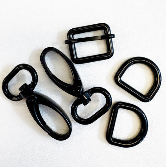 Set of black metal buckles on a white background