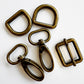 Set of five brass buckles on a white background