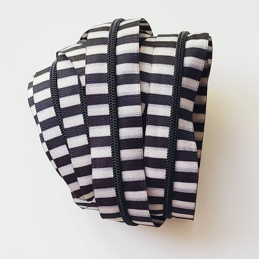Striped zipper tape and black zipper pulls.