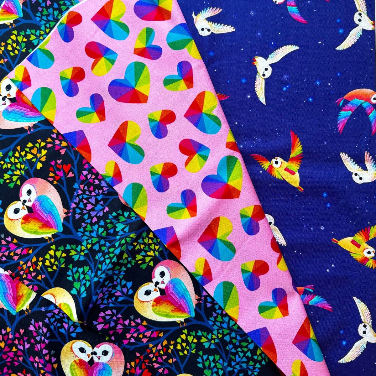 This is the Love Under the Stars fabric collection designed by Katy Tanis for FreeSpirit Fabrics, featuring whimsical lovers owls and rainbow heart patterns