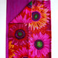 Large vibrant pink and orange sunflower print cotton fabric by Kaffe Fassett paired with a coordinating magenta pink textured tonal blender fabric for quilting and sewing.