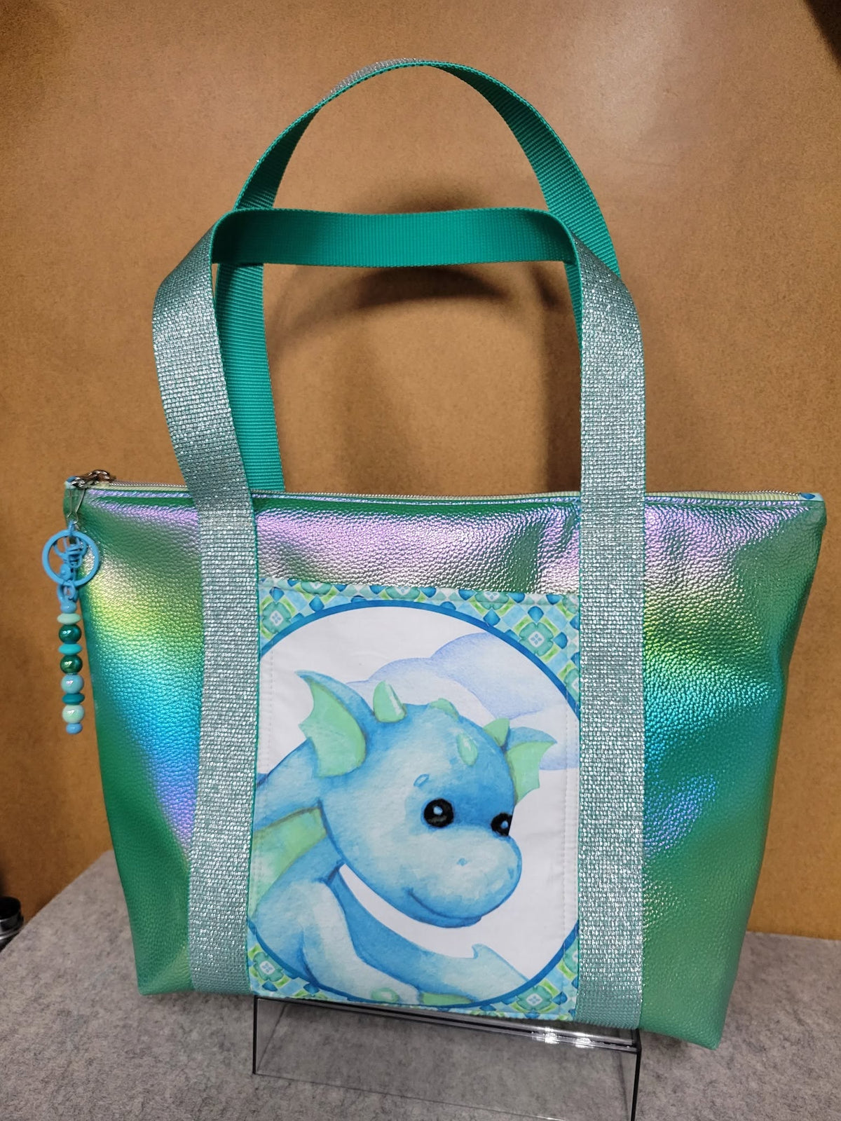 Tote in iridescent Dragon Moonglow vinyl with a baby dragon print front panel