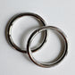 Two metallic rings on a light gray background