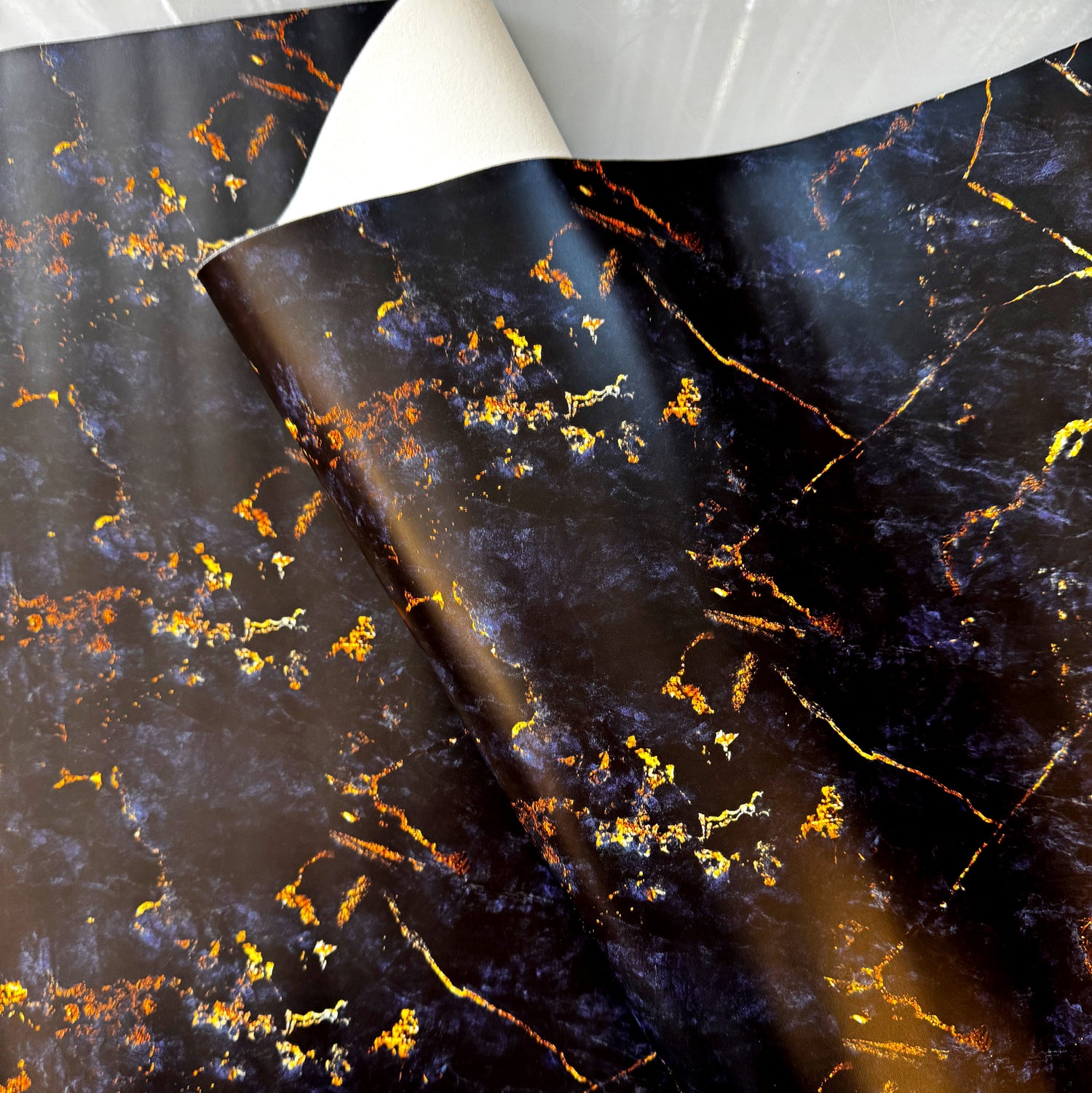 Black and gold marble patterned paper roll