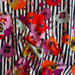 Art Gallery Fabrics Paparounes Spices softly draped. The design features a bold, artistic pattern of large watercolor-style poppy flowers in vibrant red, orange, plum purple, mustard yellow, and sage green scattered over a distressed black and white vertical striped background. 