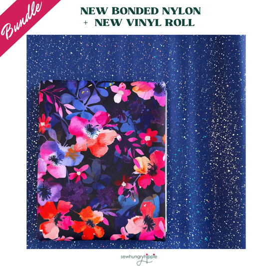 A bold watercolor floral print on a dark bonded nylon fabric pack resting on a sparkling, dark blue glitter vinyl surface for heavy-duty bag making