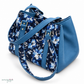 The image shows a handmade blue floral shoulder bag with solid blue side panels and matching blue straps.