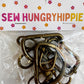 Antique brass 1.5-inch width, 5-piece hardware set by Sew HungryHippie in plastic packaging.