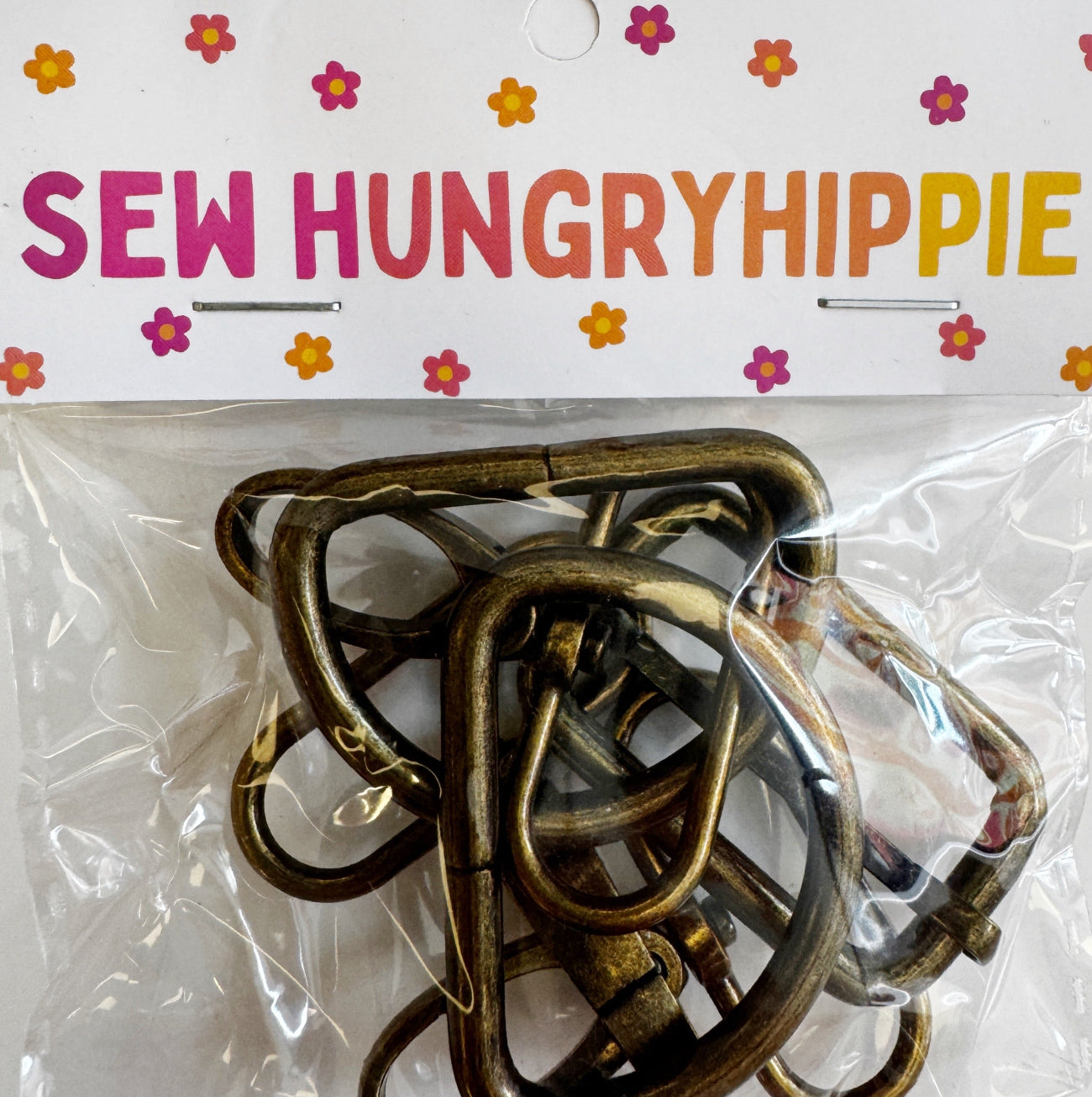 Antique brass 1.5-inch width, 5-piece hardware set by Sew HungryHippie in plastic packaging.