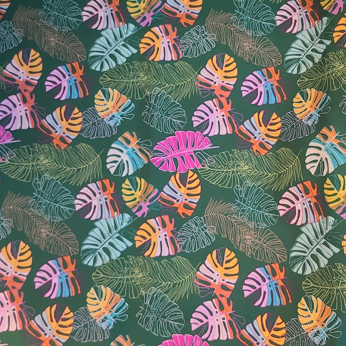 Colorful tropical leaf pattern on a green background