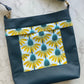 Aspen Crossbody Bag pattern by Emmaline Bags displayed with stylish finished crossbody bag sample in green moonglow vinyland yellow floral accent