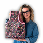 Woman holding a floral-patterned bag against a white background