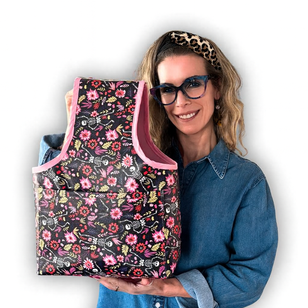 Woman holding a floral-patterned bag against a white background