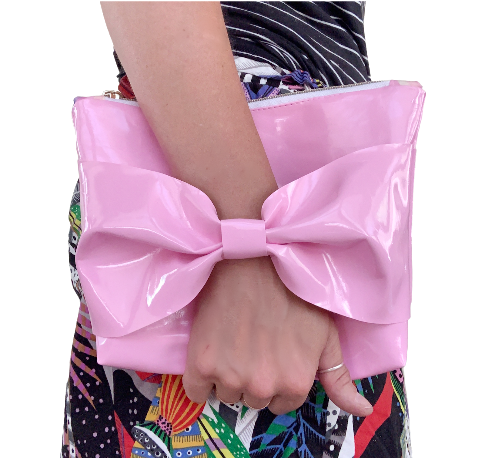 Woman holding a pink clutch with a big bow
