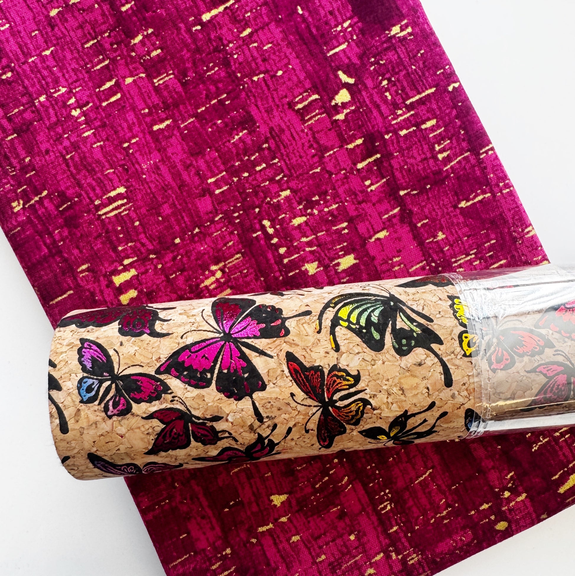 Butterfly print cork fabric roll with coordinating wineberry Uncorked fabric for bag making and sewing projects