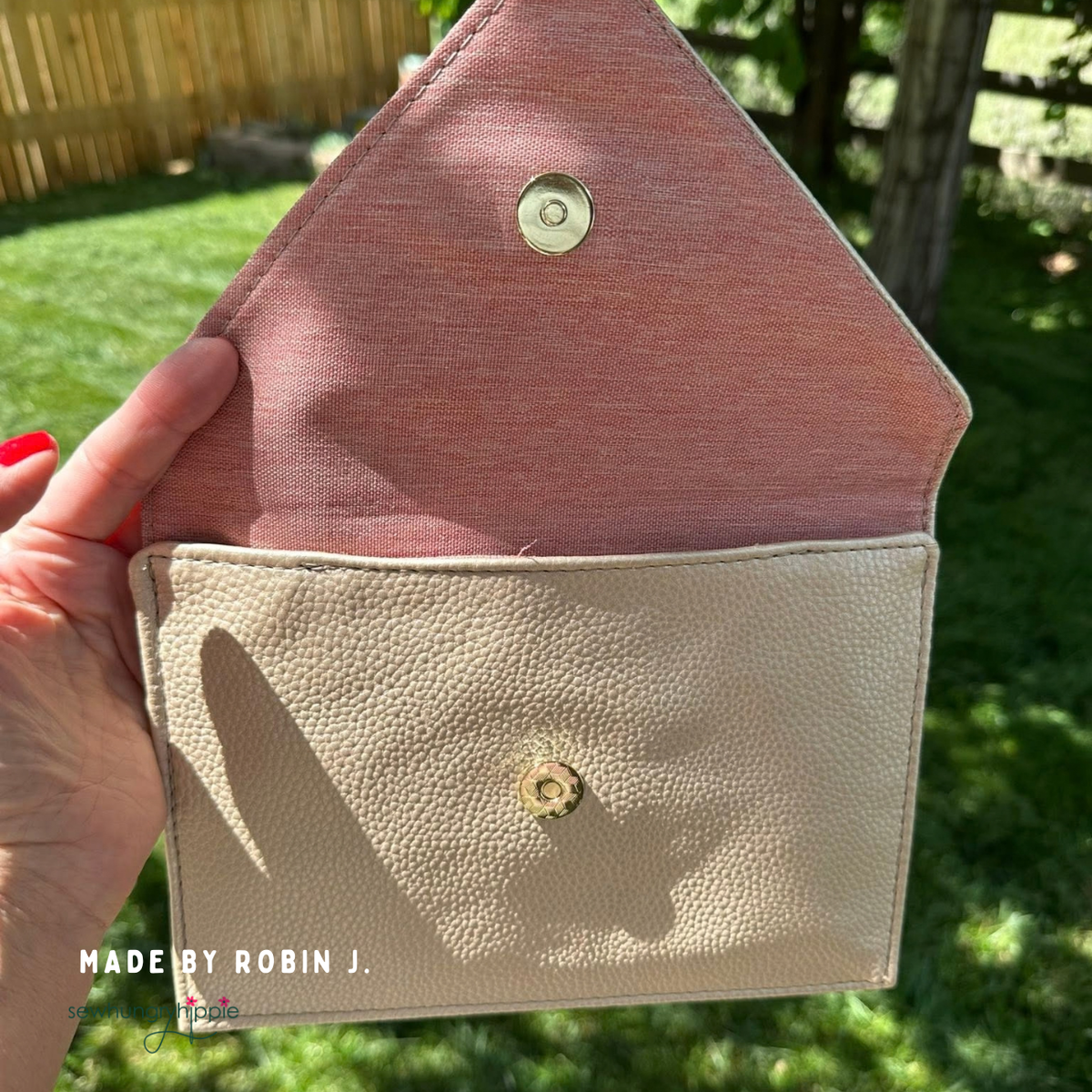 Champagne Moonglow vinyl envelope clutch opened to show pink lining and magnetic snap, made by Robin J.