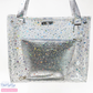 Transparent star glitter vinyl shoulder bag featuring tiny iridescent stars and silver crackle texture metallic handles.