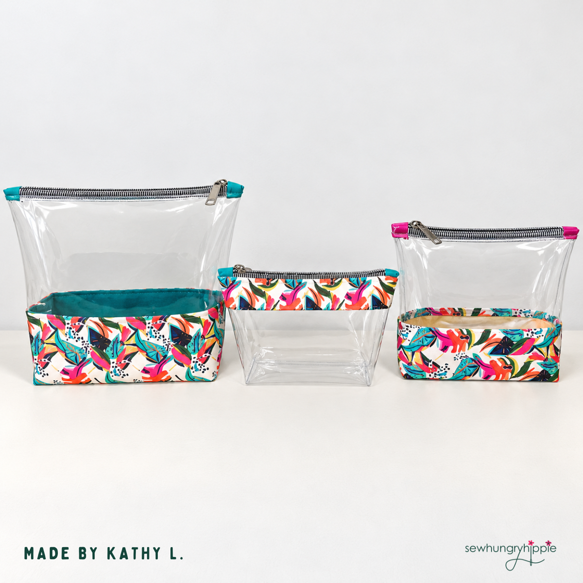 Three clear vinyl zipper pouches with tropical floral fabric bases, made by Kathy L.
