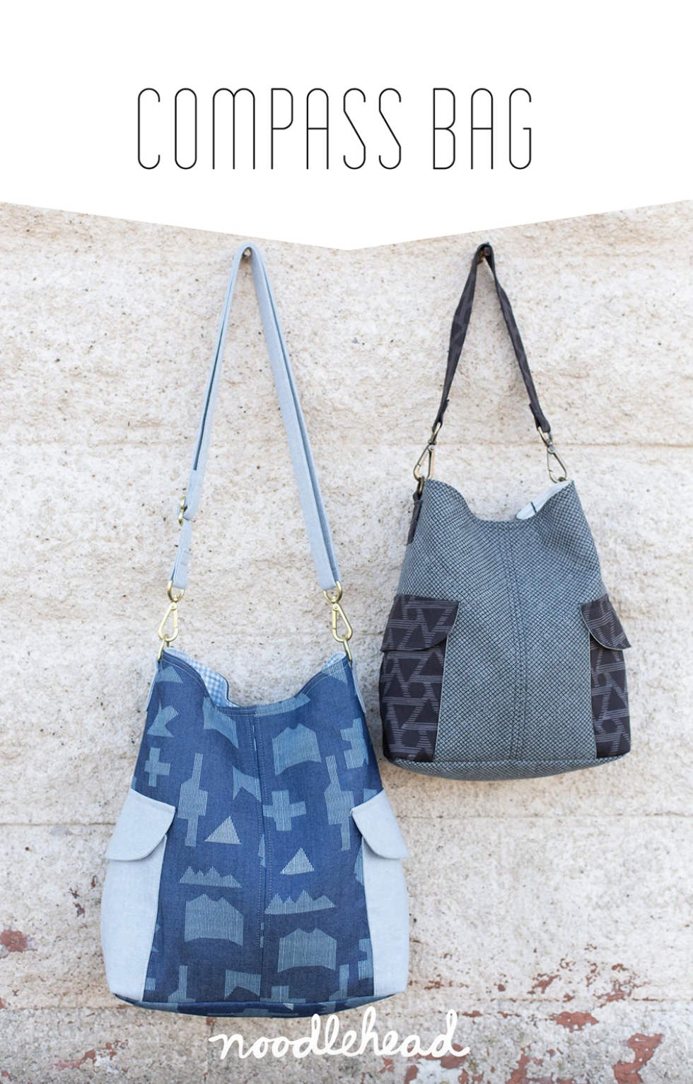 Two handbags, one blue with geometric pattern and one gray with black accents, hanging against a textured wall. Pattern name 'Compass Bag' and brand 'noodlehead' visible.