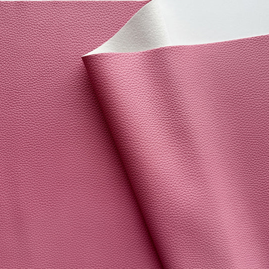 Close-up of pink leather fabric with a white edge