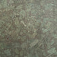Close-up of a green and brown speckled stone surface