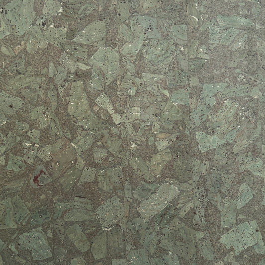Close-up of a green and brown speckled stone surface