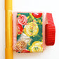 Yellow and pink Joni bag making kit with floral fabric, vinyl roll, hardware, webbing, and water resistant canvas
