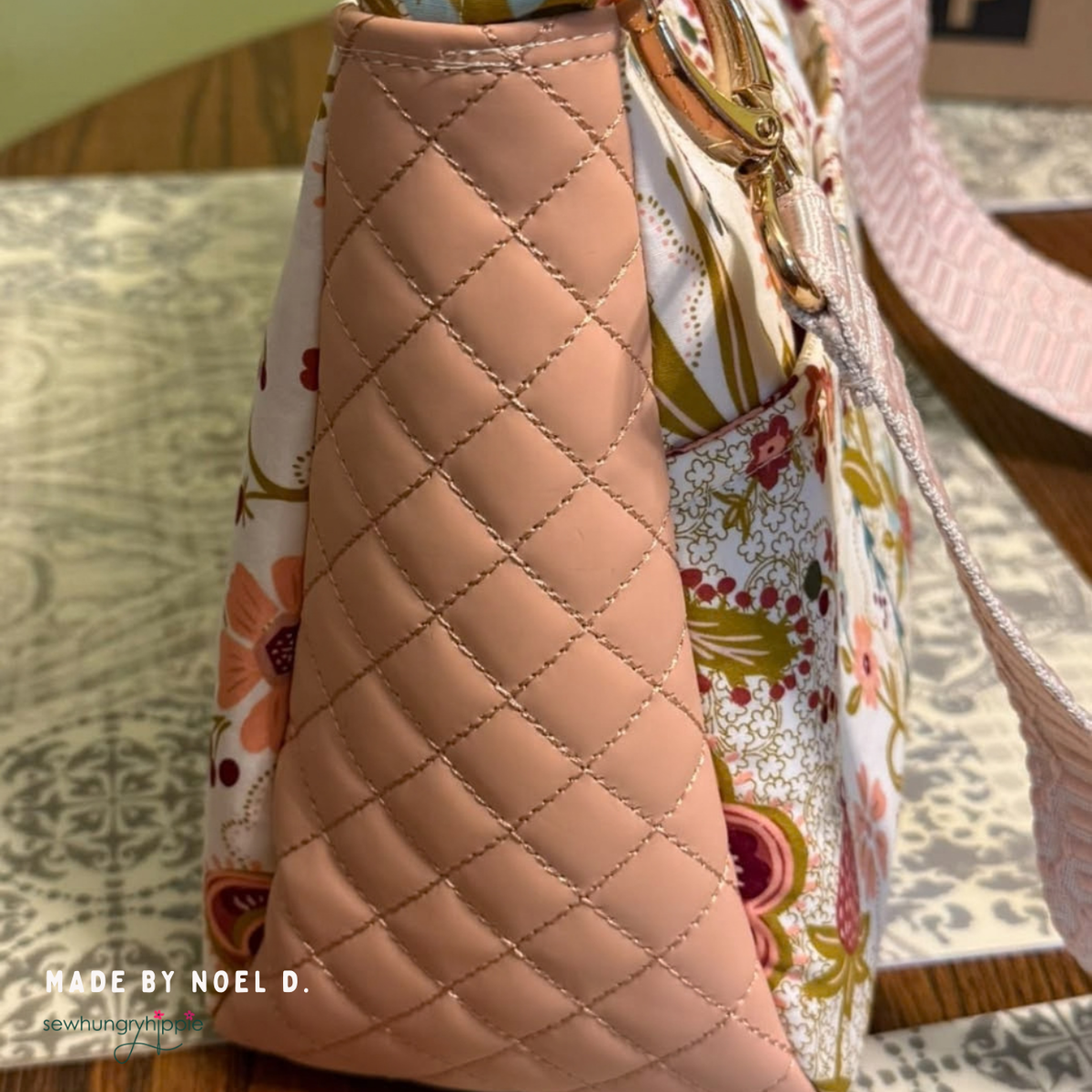 Side view of a Peachy Keen quilted vinyl bag with a floral panel