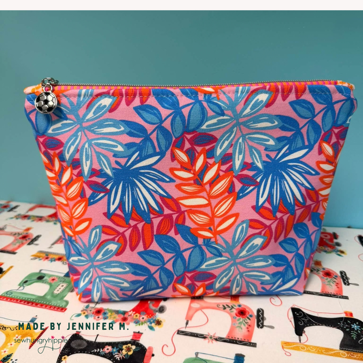 Zipper pouch in pink and blue tropical leaf canvas, made by Jennifer H.