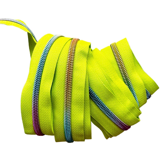 A coiled bundle of bright neon yellow zipper tape with metallic zipper teeth in multiple colors, including blue, orange, and purple, shown on a plain light background.